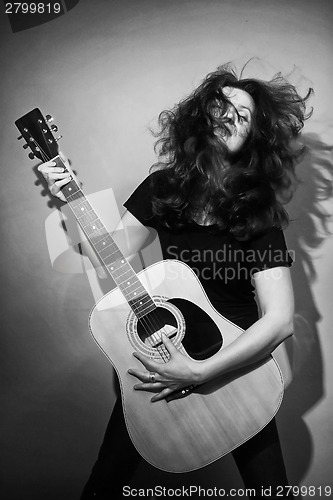 Image of Woman with rock guitar