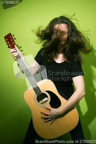 Image of Guitar woman with tousled hair