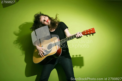 Image of Woman playing guitar