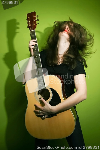 Image of Rock woman enjoying guitar