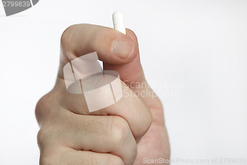 Image of Man in blue shirt takes pills