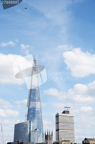 Image of Aircraft flying high above The Shard in London, England