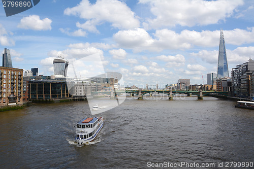Image of Boats sail the River Thames in London, England