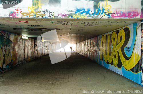 Image of underground crossing with graffiti smeared walls 