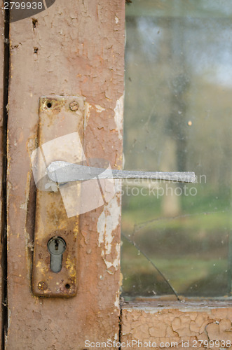 Image of door fragment with old door handle with key hole 