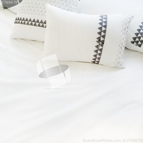 Image of Elegant white bed linen with pillows