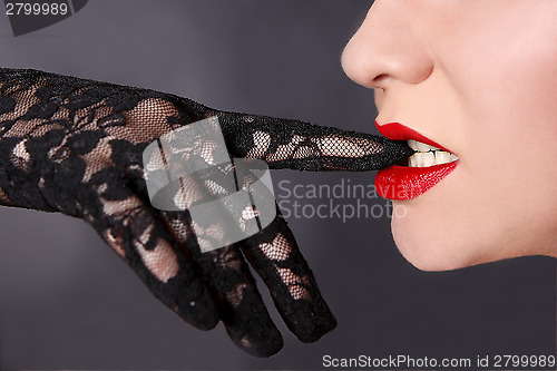 Image of Young woman wearing black top glove