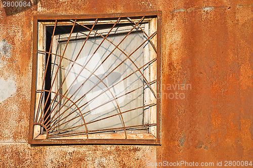 Image of Old window on the rusty wall.