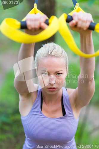 Image of Training with fitness straps outdoors.