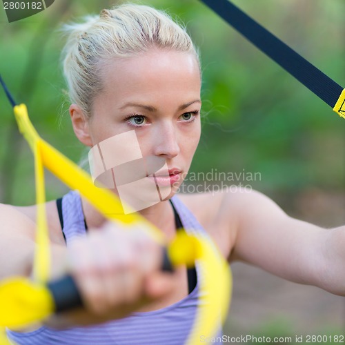 Image of Training with fitness straps outdoors.