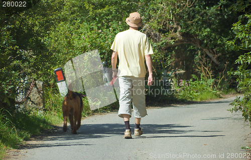 Image of Male Walking with Dog