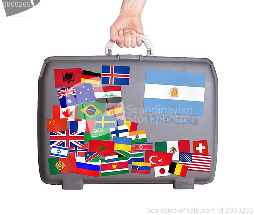 Image of Used plastic suitcase with stickers