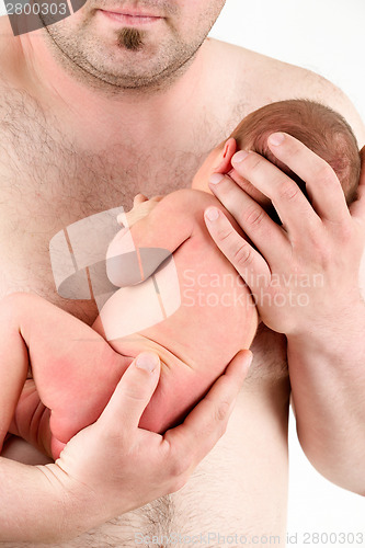 Image of hands of a father holding his newborn baby girl 