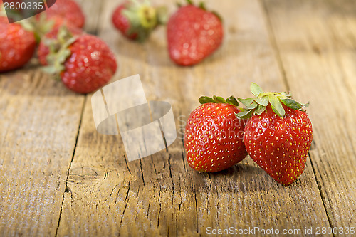Image of Fresh strawberries on wooden table