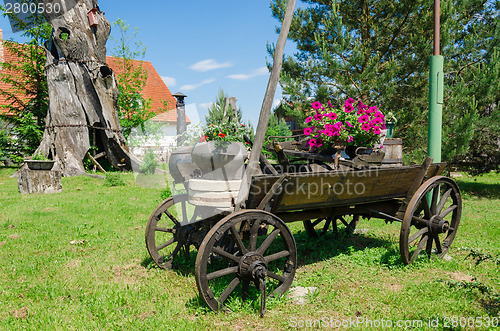 Image of rustic wooden carriage with flower composition  