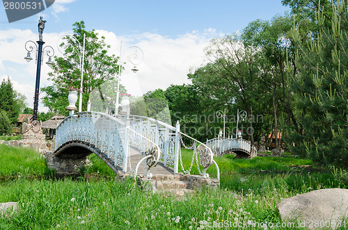 Image of antique white bridge with spectacular park lights
