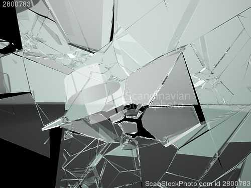 Image of Many large pieces of shattered glass isolated on black 