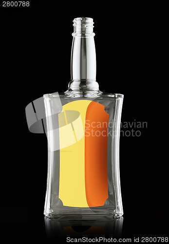 Image of Empty bottle for rum or whisky with golden labe