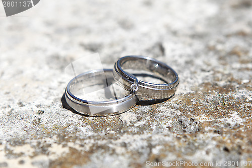 Image of Wedding rings on a stone wall