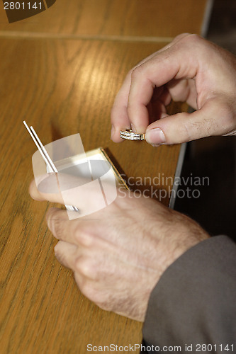 Image of Hands of the groom with wedding rings