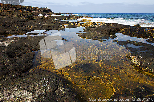 Image of beach  light     lanzarote foam rock spain    stone sky cloud   