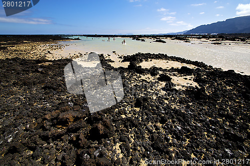 Image of people spain  hill white  beach  spiral  black    lanzarote 