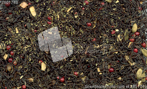 Image of Indian masala tea with pink peppercorn as background