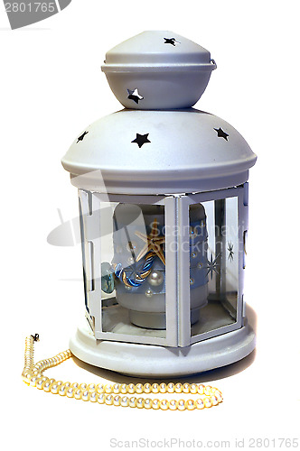 Image of Light candle in form of a lantern in a maritime style and pearls