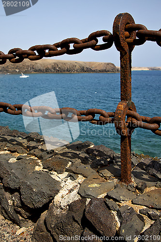 Image of rusty chain  water  boat  and summer in lanzarote spain