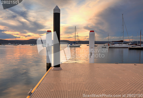 Image of Boats and yachts moored at sunset