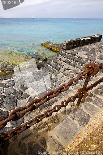 Image of pier rusty chain  water  in lanzarote spain