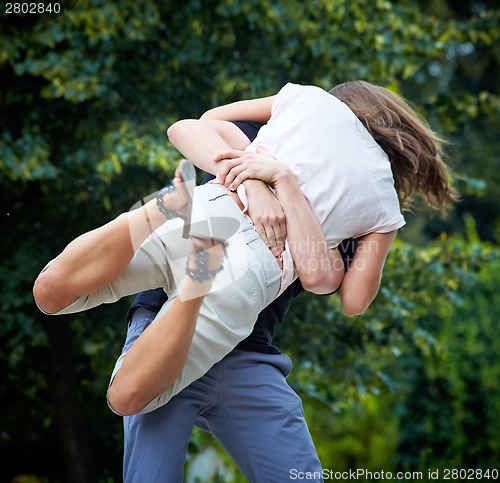 Image of Man lifts up girl