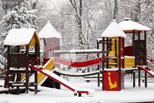 Image of Children playground on snow blizzard