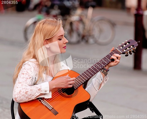 Image of Beautiful woman with guitar