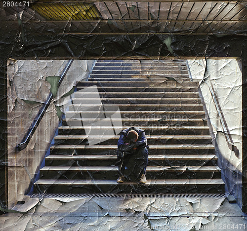 Image of Lonely man sitting on the stairs