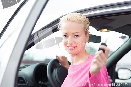 Image of Woman driver showing car keys.