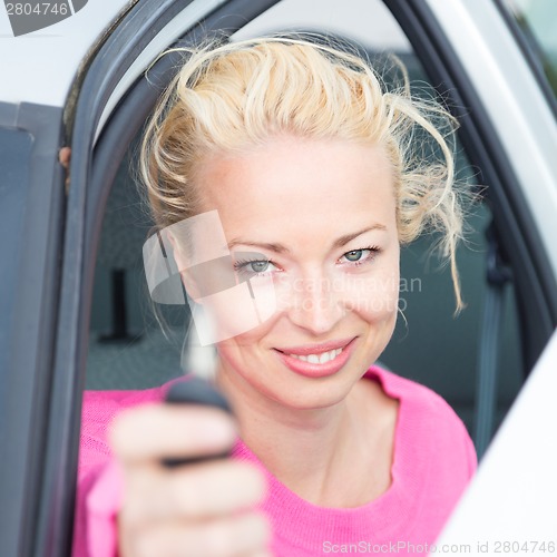 Image of Woman driver showing car keys.