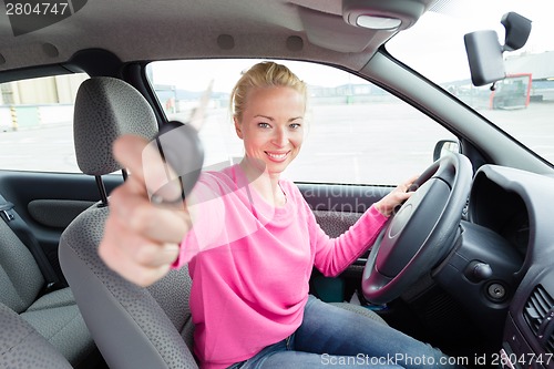 Image of Woman driver showing car keys.