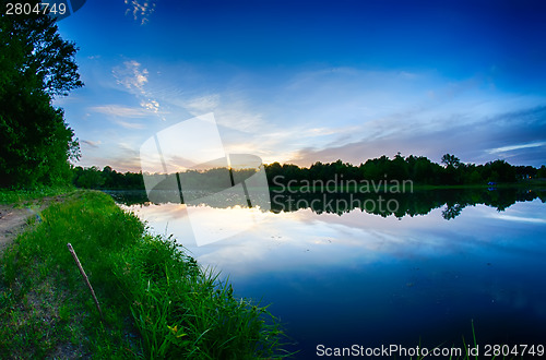 Image of sun setting over a reflective lake