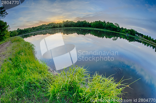 Image of sun setting over a reflective lake