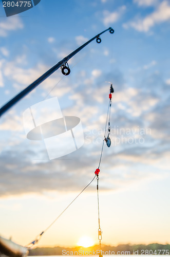 Image of fishing on a lake before sunset