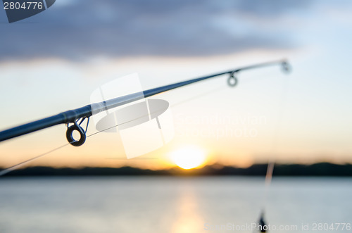 Image of fishing on a lake before sunset