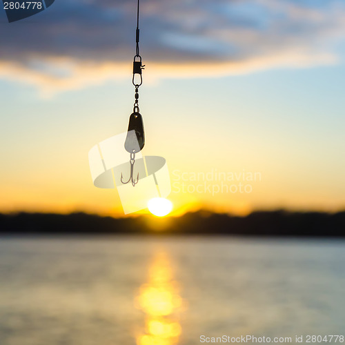 Image of fishing on a lake before sunset