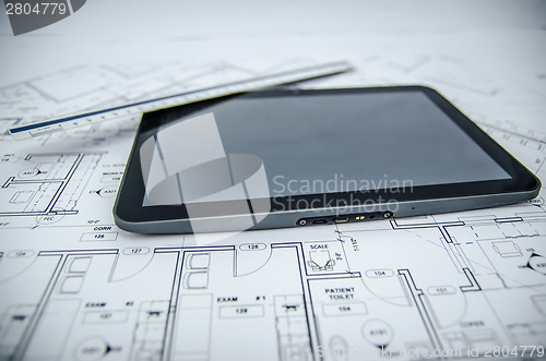 Image of tablet and architectural construction design document tools back