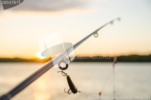 Image of fishing on a lake before sunset