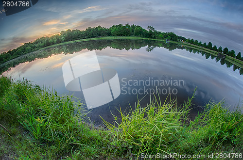 Image of sun setting over a reflective lake