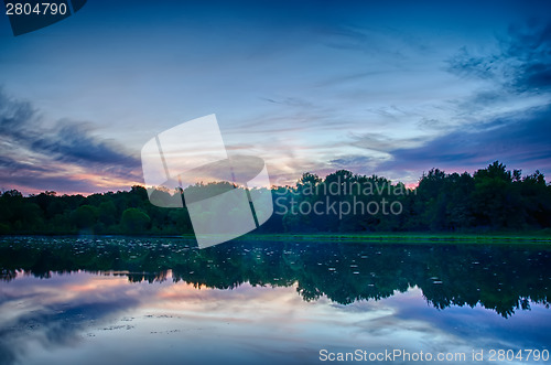 Image of sun setting over a reflective lake