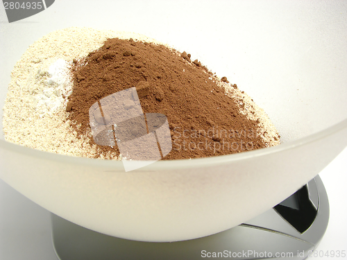 Image of Wholemeal, cocoa and baking powder on a digital scales