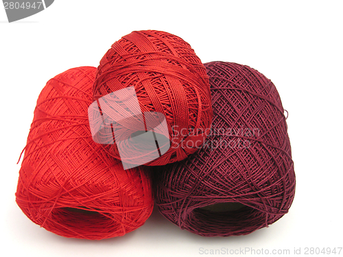 Image of Red balls of wool  on a white background