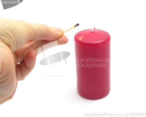 Image of Hand, burnt down match and candle
